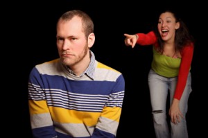 young man is being laughed about by young woman in front of black background