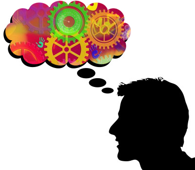 Illustration of a man's head with thought bubble filled with colors and gears