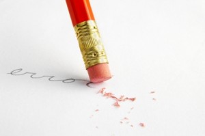 A pencil eraser scrubbing out text