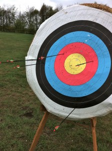 Archery target with arrows around the edge