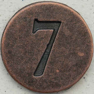Number 7 stamped in copper circle