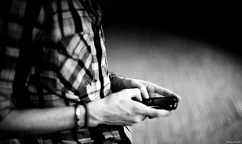 man texting black and white