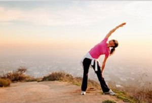 woman stretches before run while tracking personal fitness