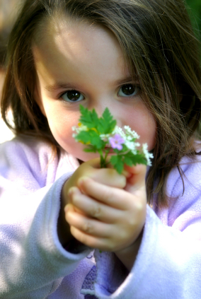 Little girl offers flower