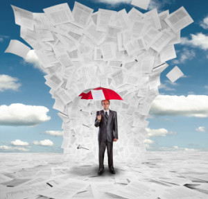 Businessman with red umbrella under huge wave of documents