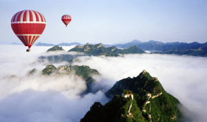 hot air balloons over clouds