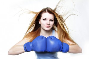 young woman in boxing gloves isolated over white