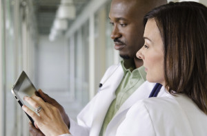 doctors review patient updates on a tablet