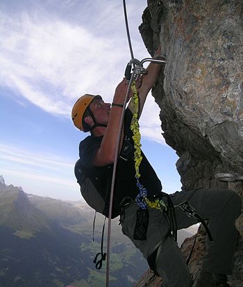 English: Climber on fixed rope route Piz Mitge...