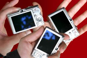 hands holding digital cameras