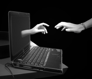 computer with hand reaching in/out