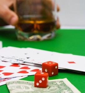 Red dice and playing cards on a casino table