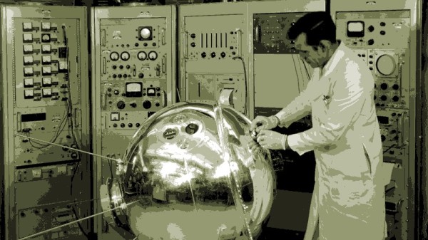 Scientist looking at a spherical metal object