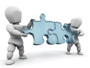 Clipart Illustration of Two White Characters Holding Blue Jigsaw Puzzle Pieces And Fitting Them Together