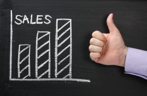 Sales Growth on a blackboard with Thumbs Up