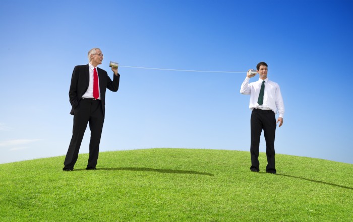 Business Men Outdoors Talking Through Tin Can Phone