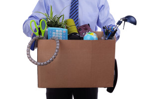 Unemployment concept, fired man with personal items in a box