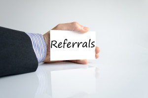 Bussines man hand writing Referrals