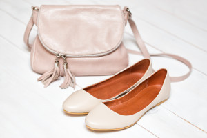 cross-body handbag and shoes on a white background