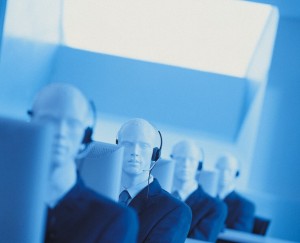 Line of Telesales Dummies Sitting Behind Computer Monitors