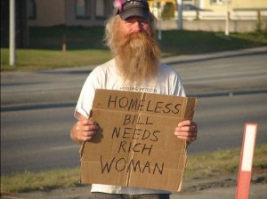 photo of a homeless man holding a cardboard sign that says "need rich woman"