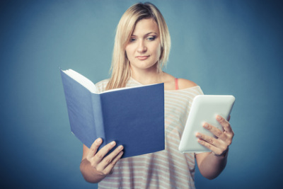Woman with book and ebook
