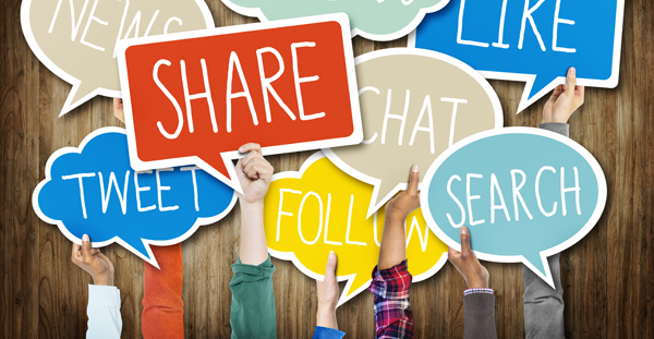 Hands Holding Speech Bubbles with Social Media Words