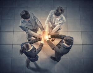 Top view of business people with hands in stack
