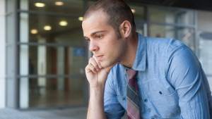 Frustrated young, handsome businessman at office