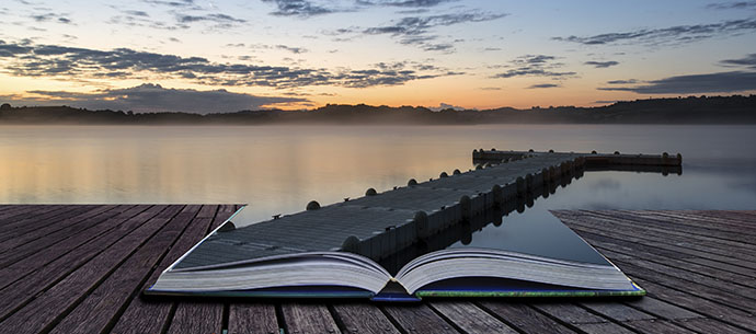 Sunrise landscape of jetty on calm lake conceptual book image