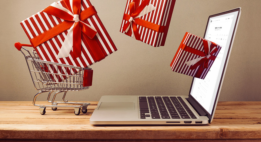 Presents flying out a tiny shopping cart and flying towards a laptop screen
