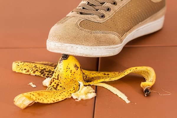 A person is about to step on a banana peel