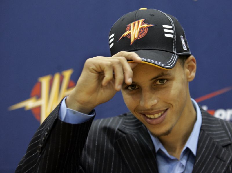 Golden State Warriors draft pick Stephen Curry tips his hat during a news conference.