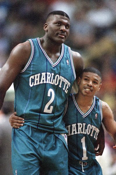 Larry Johnson (left) hugs Charlotte Hornets teammate Muggsy Bogues during the final seconds of an overtime win in 1993.