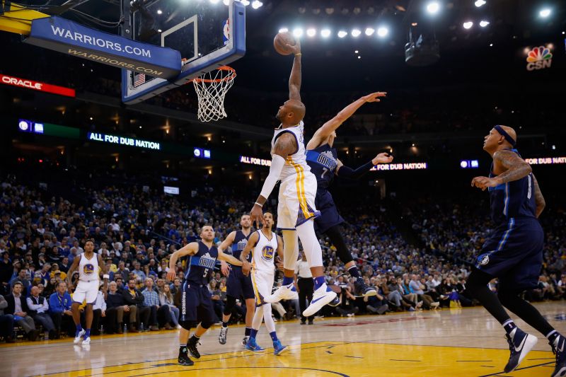 Marreese Speights of the Golden State Warriors skies for a dunk attempt against the Dallas Mavericks.