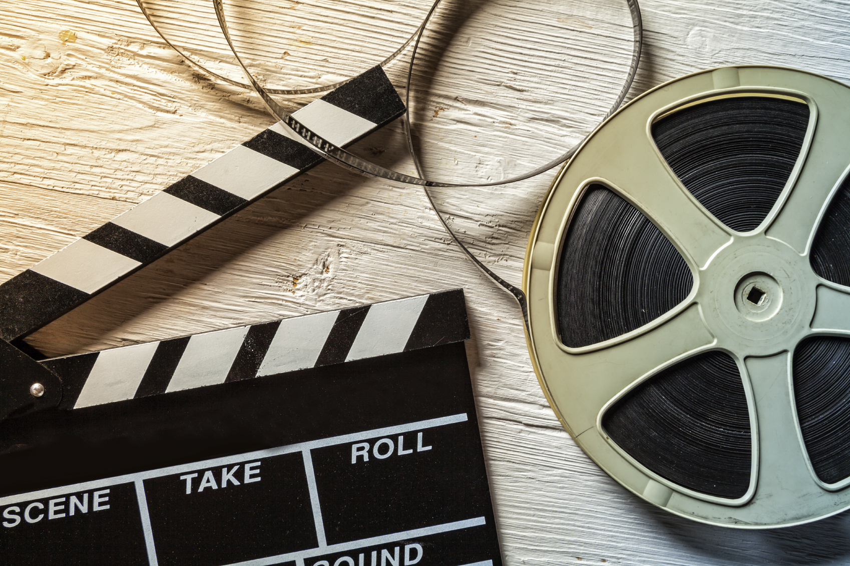 Film camera chalkboard and roll on wooden table