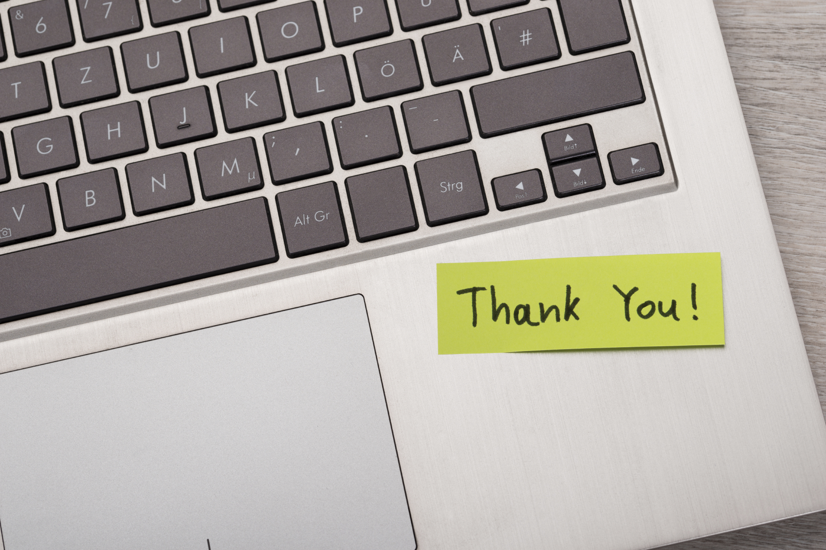 Closeup of Thank You ! sticky note message on laptop