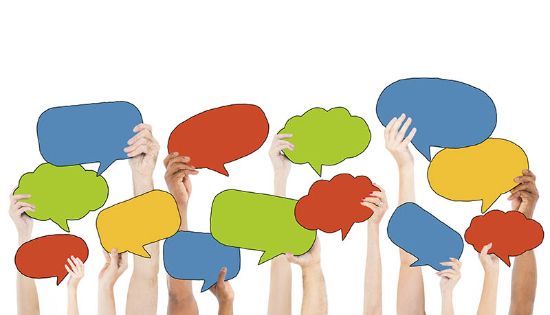 Multi-Ethnic Group of Hands Holding Speech Bubbles