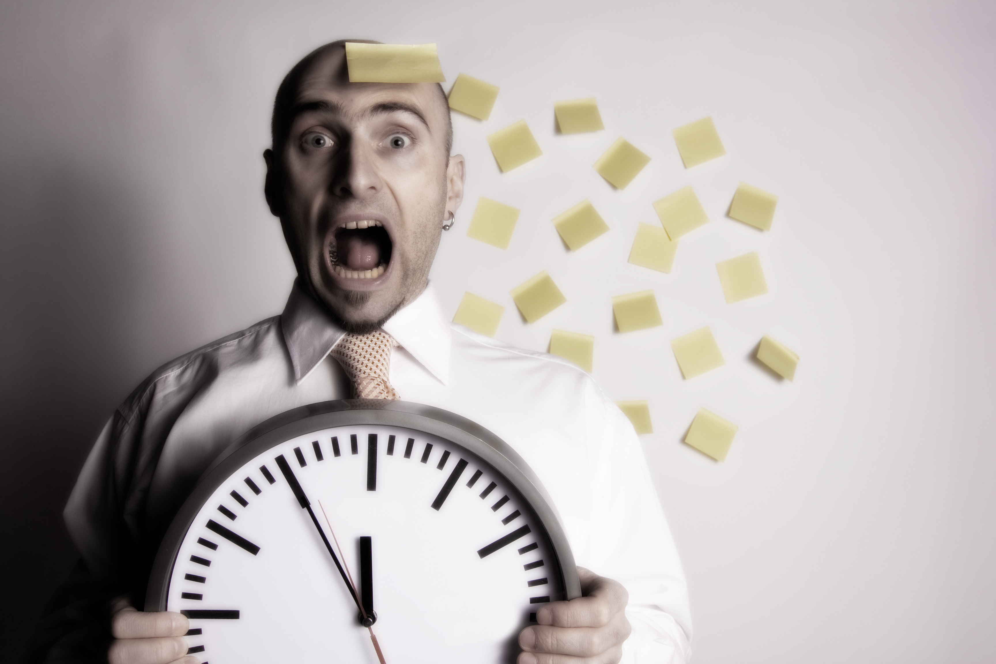 Frantic, unorganized businessman unsuccessfully tries to use many post-it notes to remind him of his busy schedule and appointments.