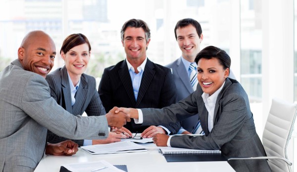 A diverse business group closing a deal in the office
