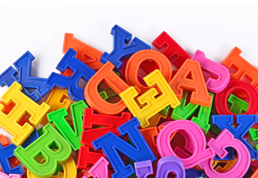 Colorful plastic alphabet letters on a white background