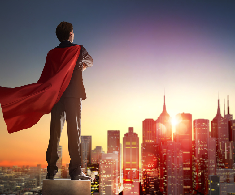 superhero businessman looking at city skyline at sunset. the concept of success, leadership and victory in business.