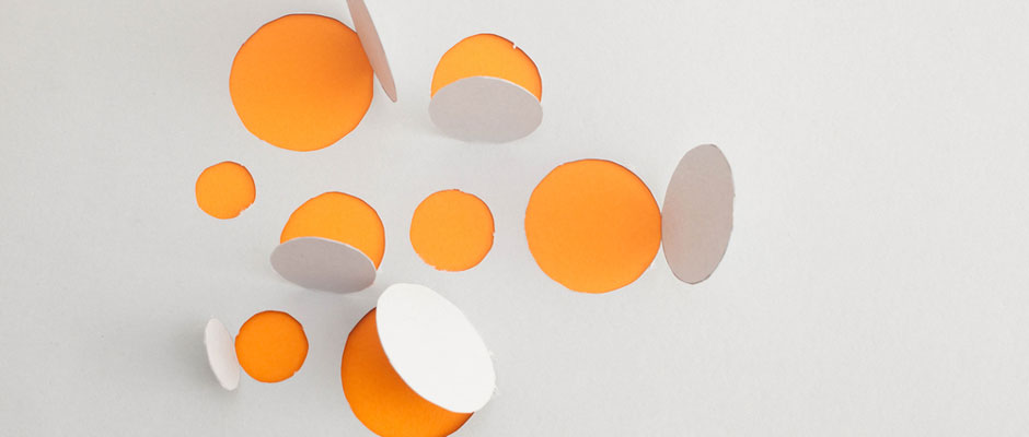 Sculptural paper art with circular window openings