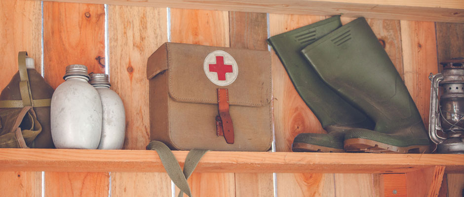 Wooden shelf with retro surival kit and green boots