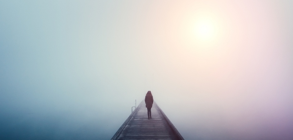 woman on a bridge in the mist