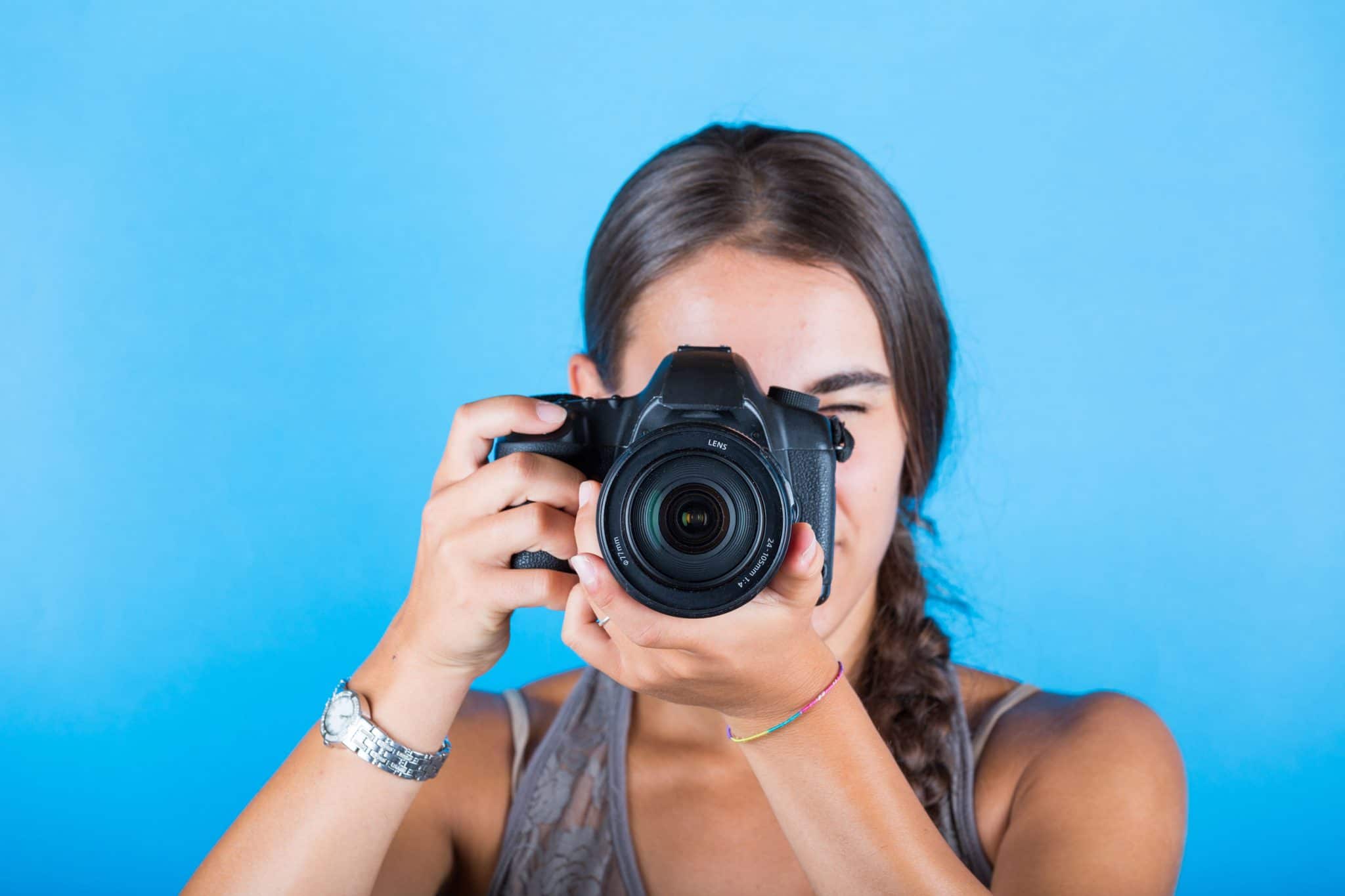 A young woman taking pictures with a professional camera. 