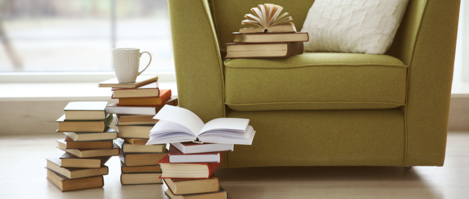 a stack of books on a green chair