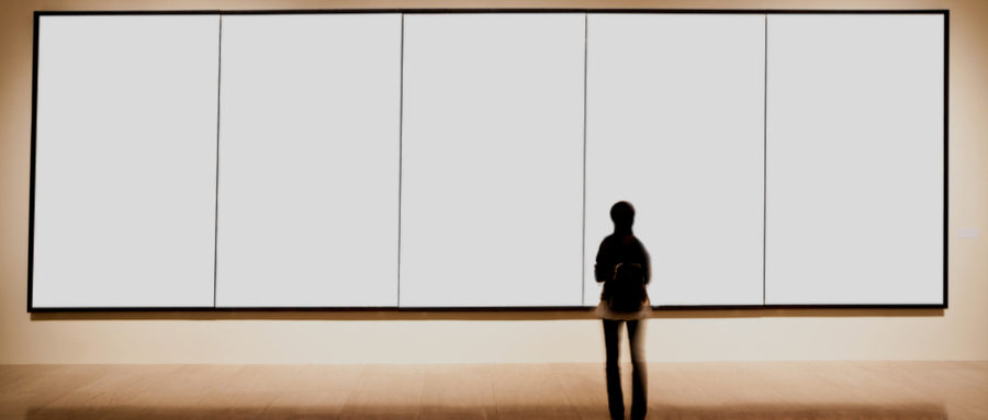 a woman looking at a minimalist art display