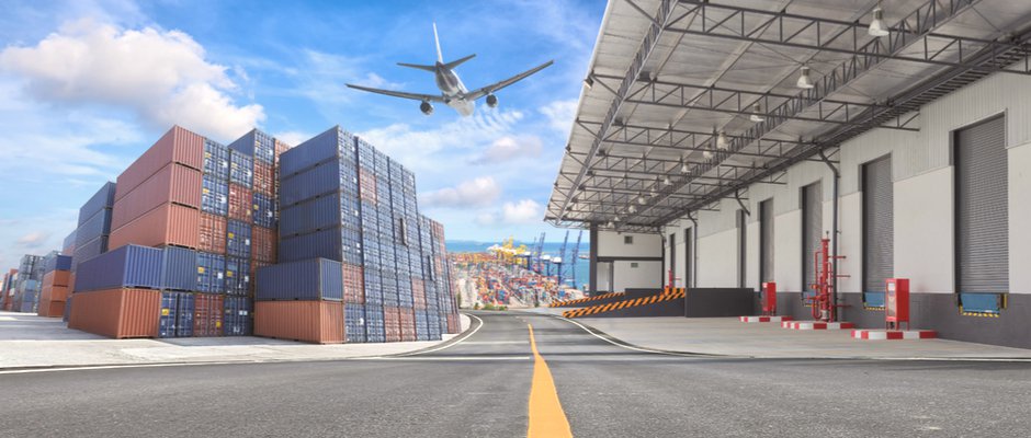 a plane flying over a warehouse