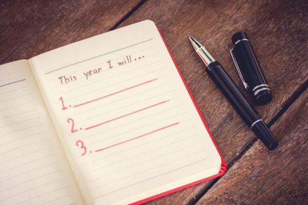 50056574 - new year resolution, empty list. on wooden table